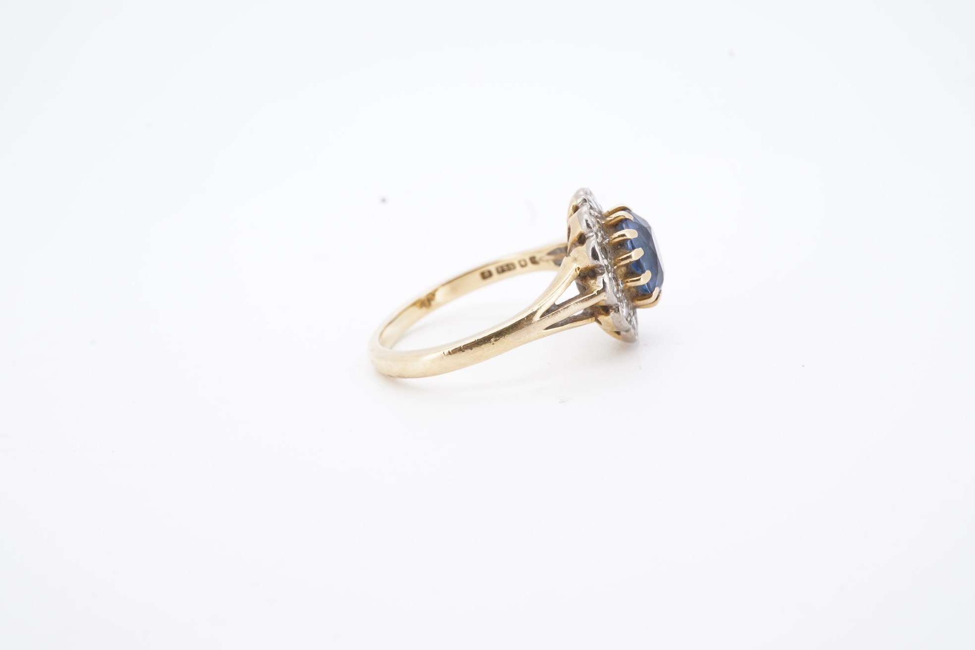 A 1980's 18ct gold, sapphire and diamond set oval cluster ring, size K, gross weight 3.8 grams.